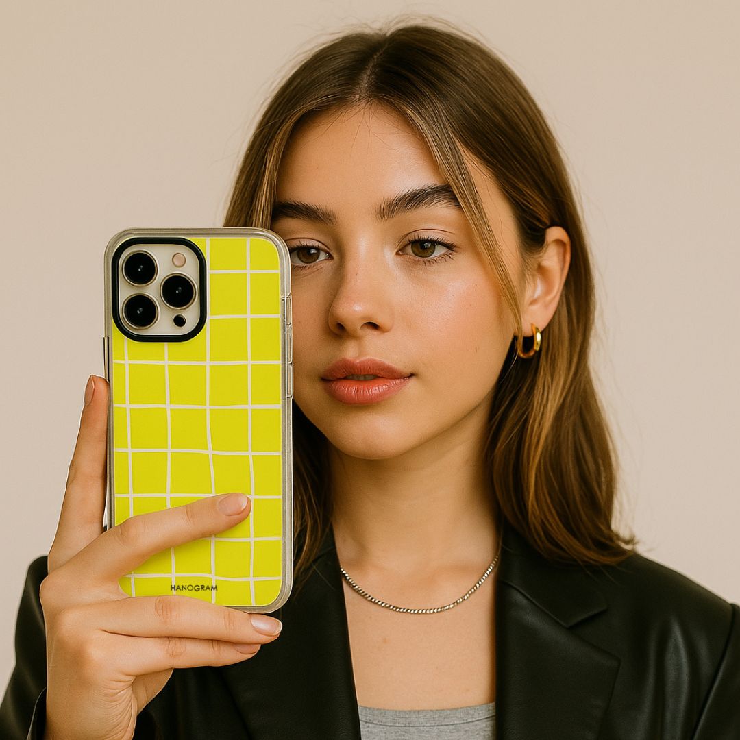 Woman holding a bright yellow personalized HANOGRAM iPhone case